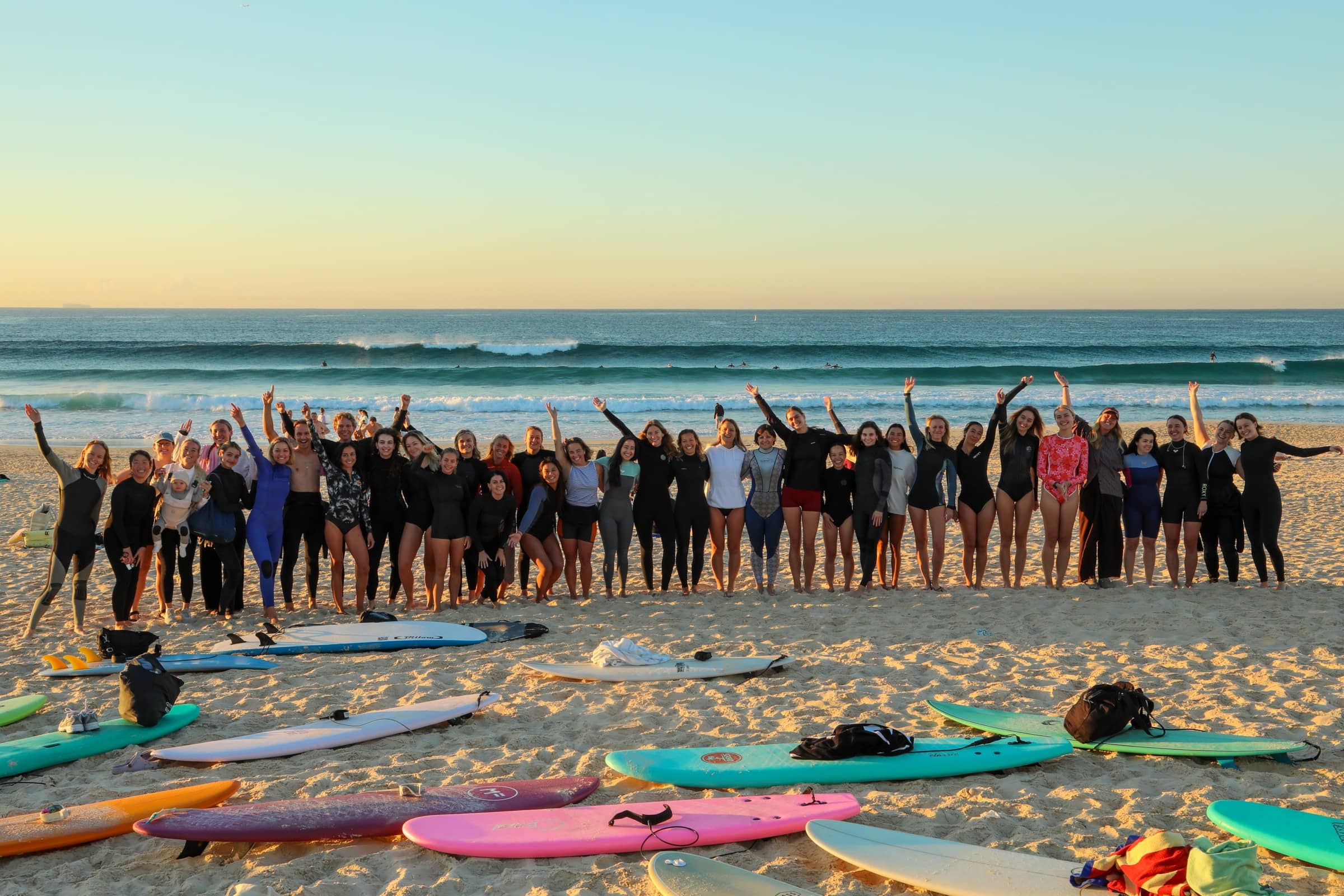 Bondi Surf Sisters paddling out at sunrise